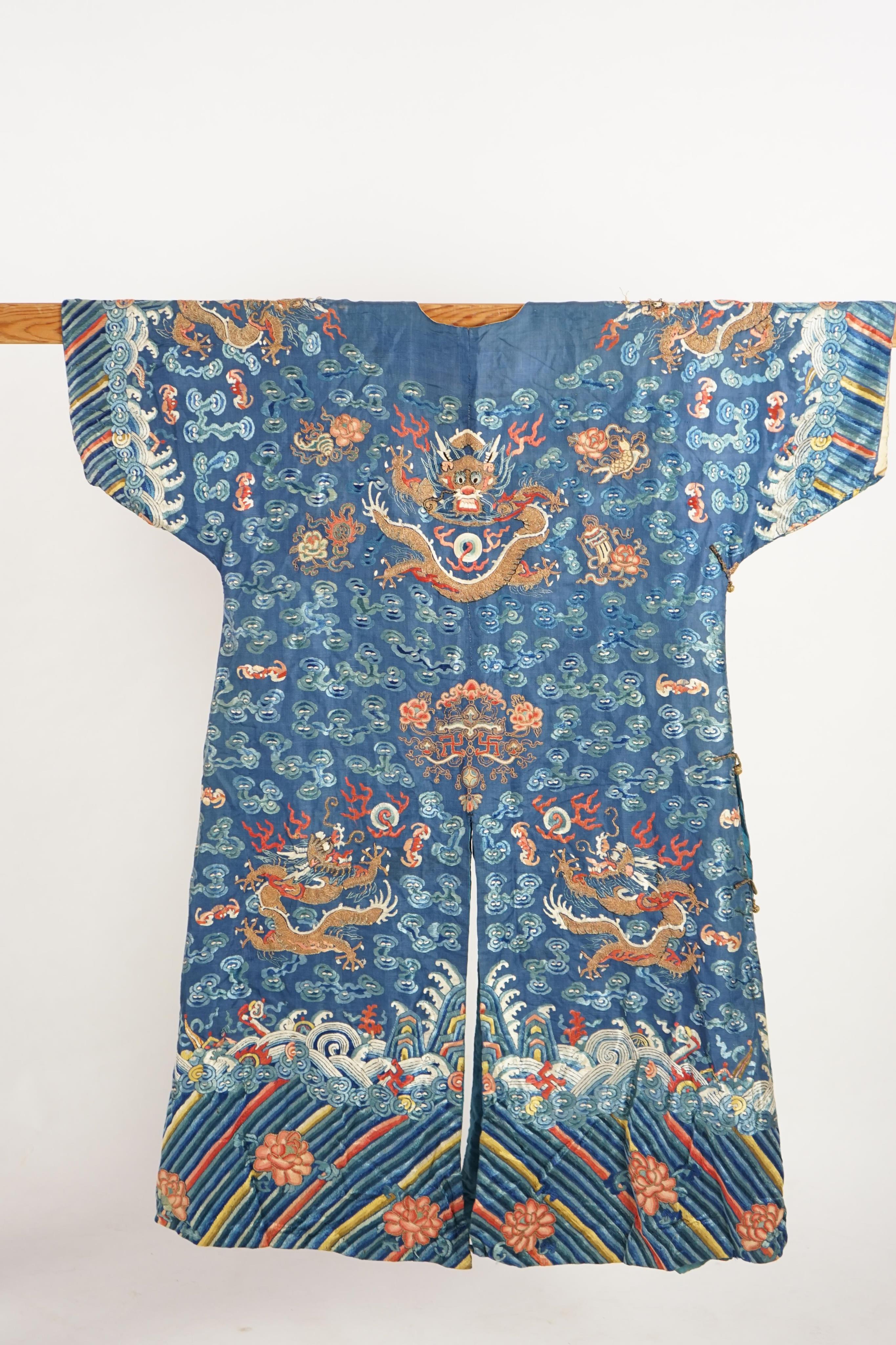 A Chinese blue silk ‘dragon’ robe, jifu, late 19th century and a mandarin hat